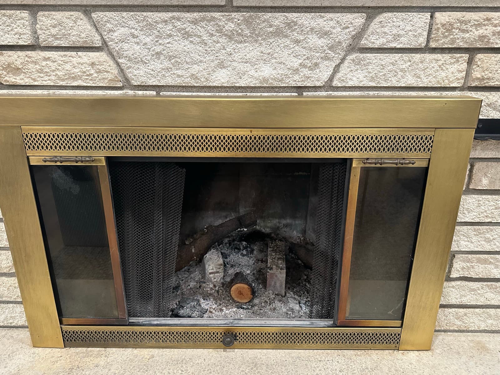 Home Cleaning in Tacoma, WA — Living Room before cleaning: Soot stains, brass tarnish, ash buildup