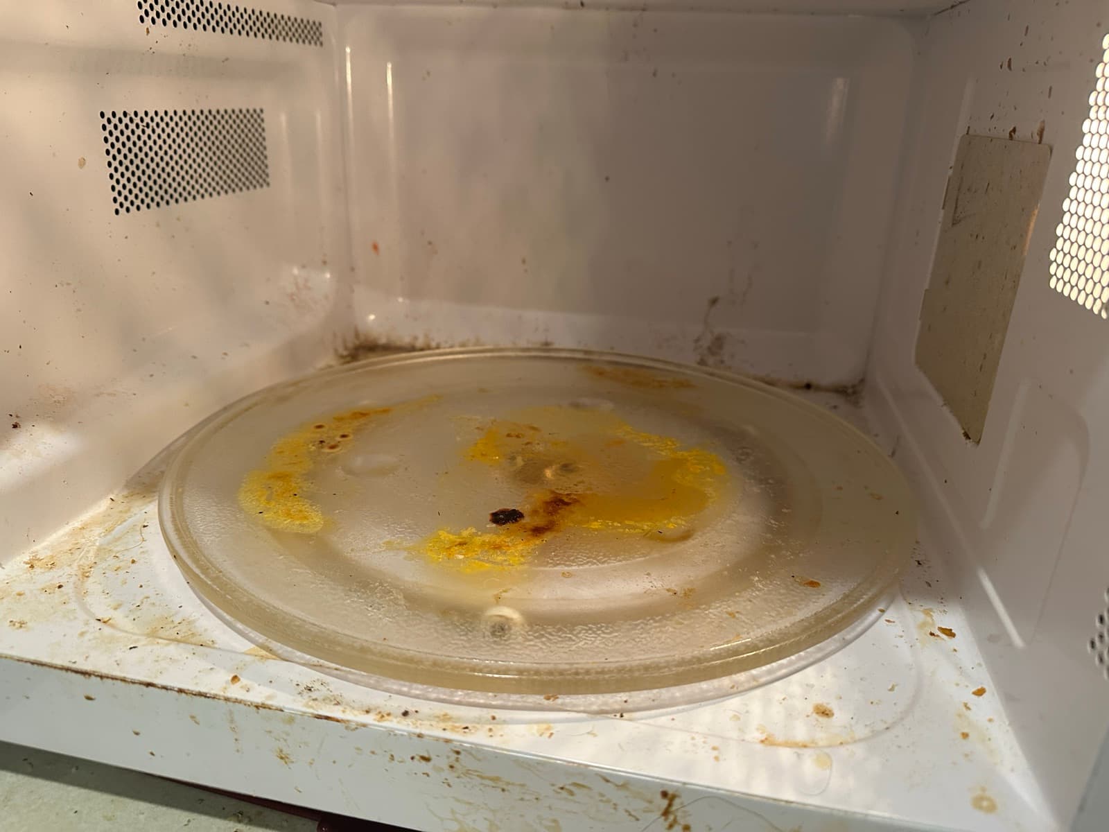 Home Cleaning in Kent, WA — Kitchen before cleaning: Splatter on walls, grease on turntable