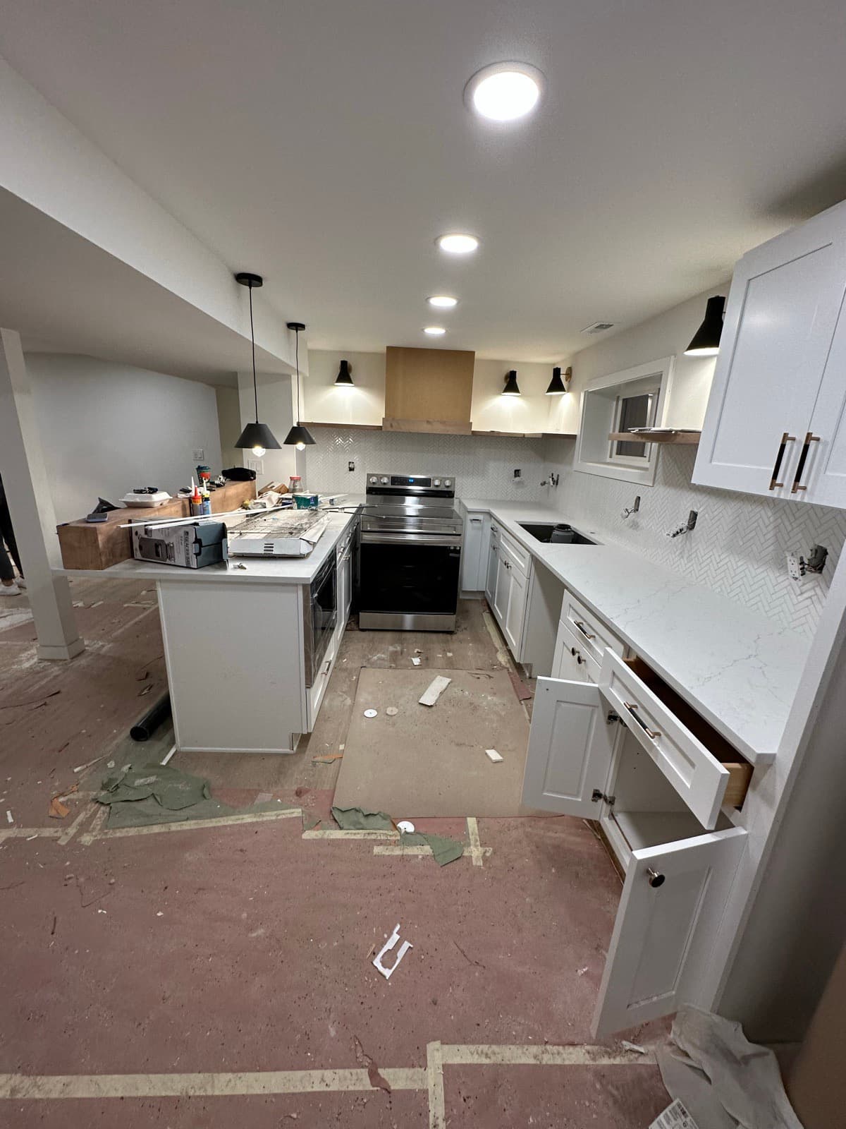 Post-Construction in Bellevue, WA — Kitchen before cleaning: Drywall dust, paint splatter, debris