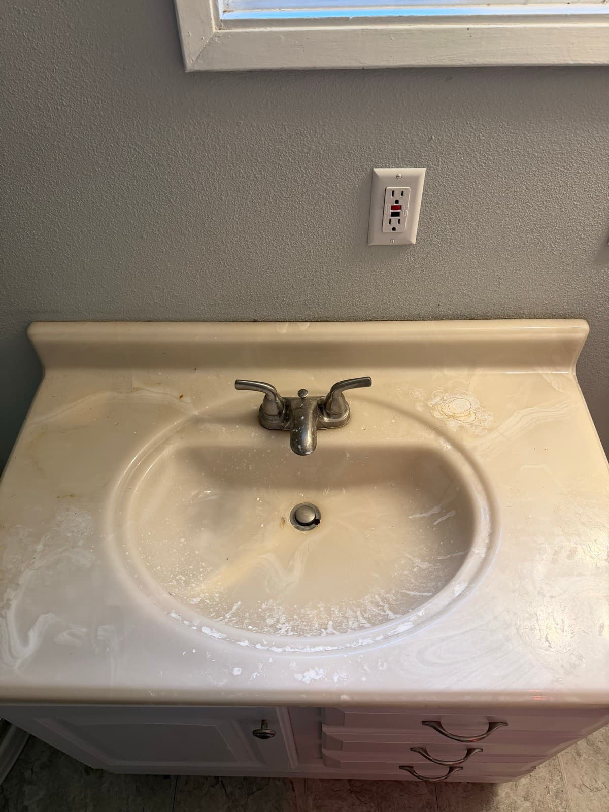 Home Cleaning in Renton, WA — Bathroom before cleaning: Yellowed basin, water spots, dingy faucet